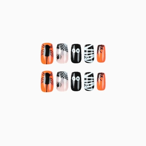 Halloween press-on nails featuring spiders, webs, and cartoon eyes in orange and black