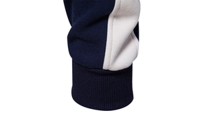 Detail view of navy and white color-blocked sweatshirt with ribbed knitted cuffs