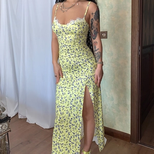 Floral slit sundress with yellow base and blue prints featuring elegant white lace trim