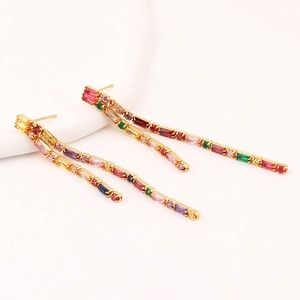Detail view of gold tassel earrings featuring colorful rainbow zircon stones in a 45-degree angle