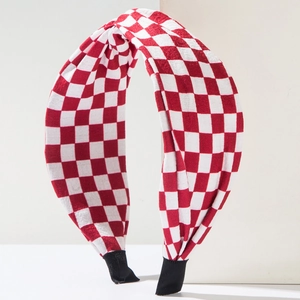 Detailed close-up of red and white checkered fabric headband with a top knotted design