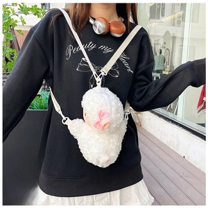 Detailed view of a white plush cat crossbody bag with a pink bow and adjustable strap