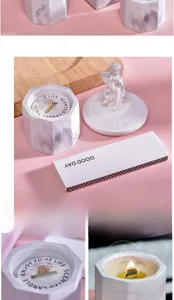 Detail of marble pattern candle holder with wood wick and angel statue lid
