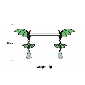 Detail of bat-shaped nipple ring in black and lime green with white drop pendant