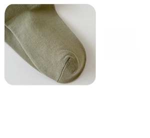 Close-up of seamless toe stitching on olive green combed cotton loose socks