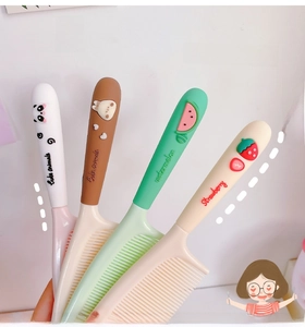 Detail of cute cartoon hairbrushes with 3D animal and fruit charms on soft silicone handles