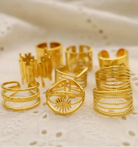 Detailed view of 18K gold plated vintage rings with evil eye motif on lace fabric