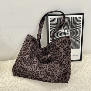 Close-up of leopard print suede tote bag placed on a plush rug for a luxury look