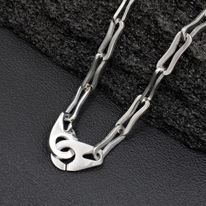 Minimalist silver titanium steel chain necklace with unique link texture on black stone