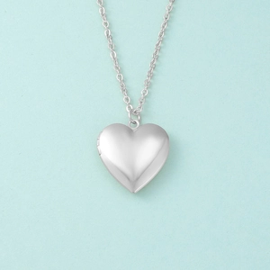 Detailed view of a silver heart-shaped photo locket pendant with a fine O-chain link