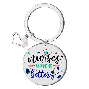 Detail of round stainless steel keychain with colorful Nurse themed printing and heart charm