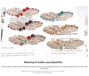 Close-up of elegant butterfly hair clips with colorful rhinestones on rose gold alloy