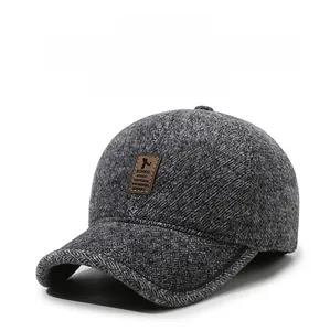 Close-up of deep grey textured wool blend baseball cap with a brown leather EDIKO label