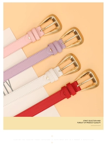 Detail of four colorful faux leather belts with golden triangular metal pin buckles