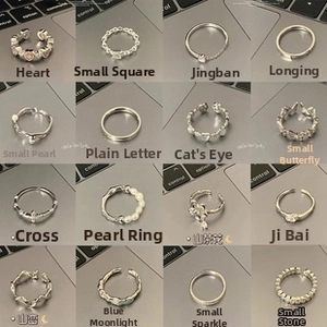 Collection of sixteen diverse silver-tone rings featuring heart and floral designs