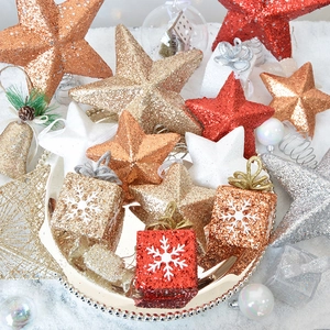Sparkly gold and red Christmas star tree hanging ornaments in decorative silver tray