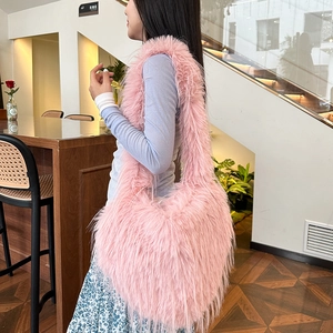 Pink faux fur shoulder bag with tassel heart detail and large capacity plush design