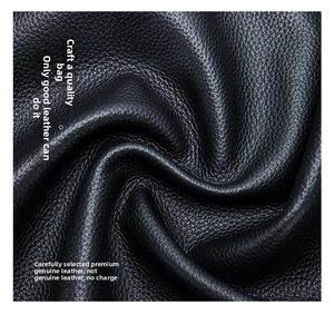 Close-up of premium black litchi pattern genuine leather texture on elephant charm