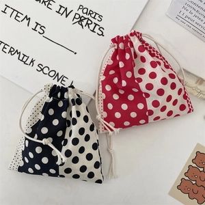 Close-up of drawstring canvas pouches with vintage polka dot patterns and cotton cords