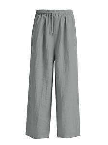 Detail of grey cotton linen trousers showing elastic waistband and drawstring texture