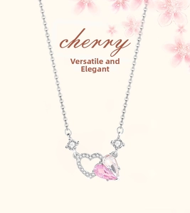 Detail of 925 silver necklace with double heart pendant featuring pink crystals