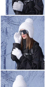 Detail of white plush winter hat with earflaps and matching gloves in snowy outdoor setting