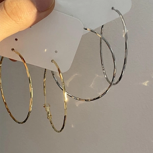 Minimalist large hammered hoop earrings in gold and silver finish with textured metal design