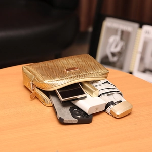 Quilted gold camera bag showing storage capacity with phone and daily essentials