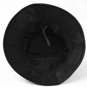 Detail view of black bucket hat lining with adjustable inner drawstring and reinforced stitching