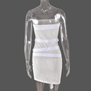 Close-up of white tube dress featuring bandage straps and textured mesh fabric