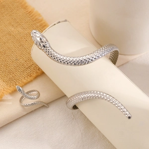 Macro detail of silver twisted snake ring and bracelet set with realistic scale textures