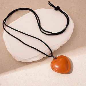 Vintage orange leather heart pendant necklace with adjustable black braided rope cord