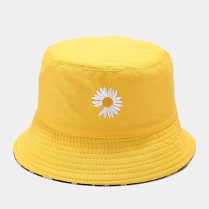 Close-up of white daisy embroidery on yellow cotton twill reversible bucket hat