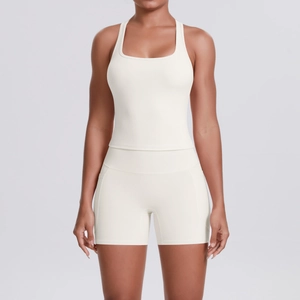 Detail of ivory seamless racerback sports top and fitted yoga shorts set for fitness