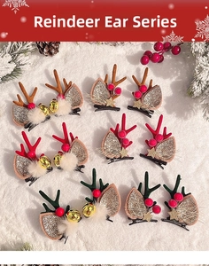 Detail of Christmas reindeer ear hair clips with fur balls and bells on snowy background