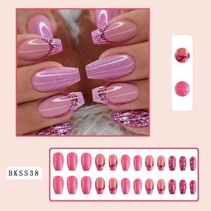 Detail of pink French press-on nails with glitter accents in medium-long coffin shape