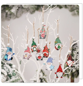 Ten unique wooden Christmas gnomes hanging on white branches with festive snow background