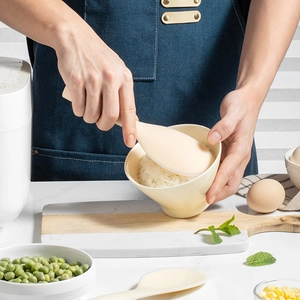 Food-grade non-stick beige silicone rice paddle with standing handle in kitchen