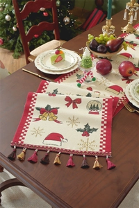 Detailed close-up of festive Christmas table runner with tassels on a dark wood table