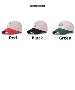 Three-color display of cotton baseball caps with heart paw prints in red, black, and green