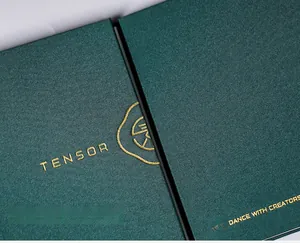 Macro view of dark green nail sticker album featuring gold foil logo and fabric texture