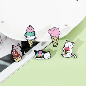 Set of five colorful cartoon cat enamel pins featuring ice cream and cake designs on a plate
