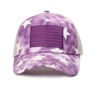 Detail of purple tie-dye trucker hat with American flag patch and star patterns