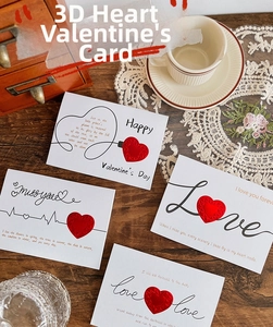 Macro detail of 3D red heart cards with elegant script on warm vintage background