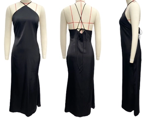 Detail of black satin maxi dress featuring a halter neck and X-shaped lace-up back design