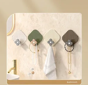 Set of four luxury wall hooks with clover design in green, beige, white, and coffee colors
