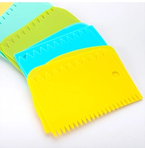 Close-up of colorful serrated and smooth plastic scrapers for baking and cake decorating