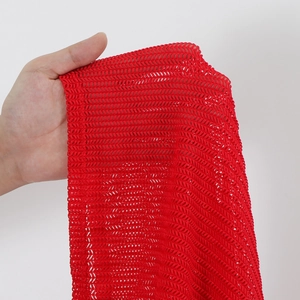Detailed view of red hollow mesh fabric with breathable diagonal weave pattern