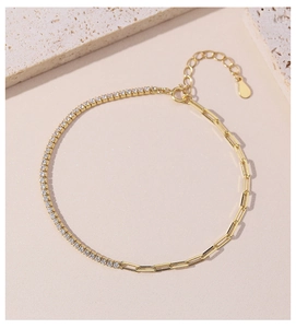Macro detail of gold-plated paperclip chain bracelet with micro-pave zircon crystals
