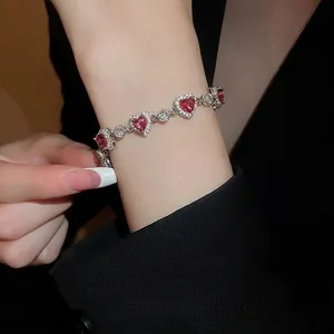 Luxurious silver bracelet featuring heart-shaped pink zircons with halo diamond setting